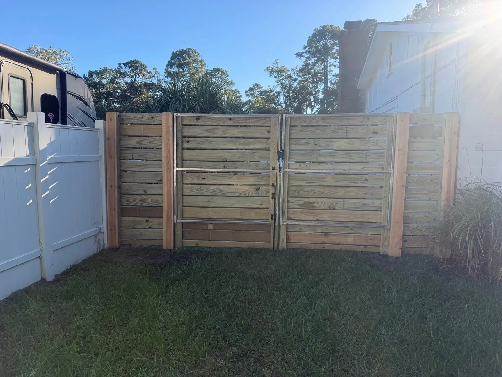 Custom horizontal wood double gate built with a metal frame